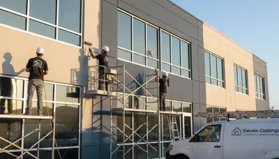 Professional commercial painters finishing office exterior in Ogden, UT