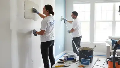 Painter repairing drywall cracks and holes in Ogden, UT home for expert wall restoration