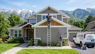 Professional house painters working on exterior home in Ogden, UT