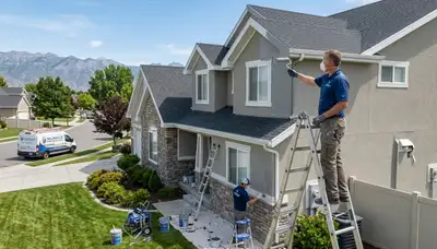 Professional house painters improving home exterior in Ogden, UT