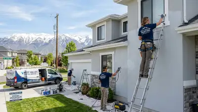 Professional house painters working on home exterior in Ogden, UT